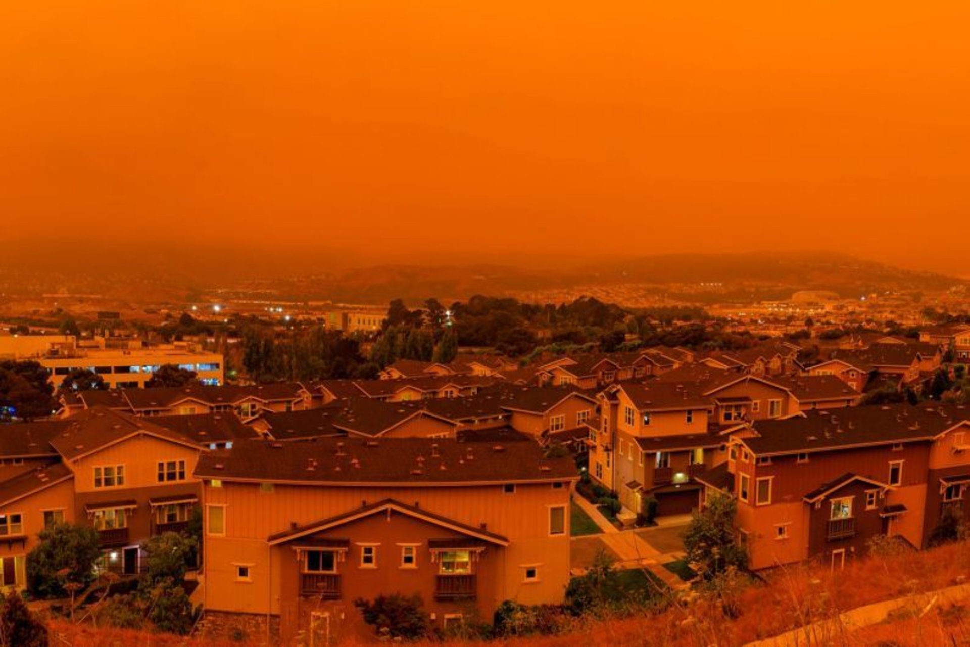Overhead view of orange sky in suburban neighborhood